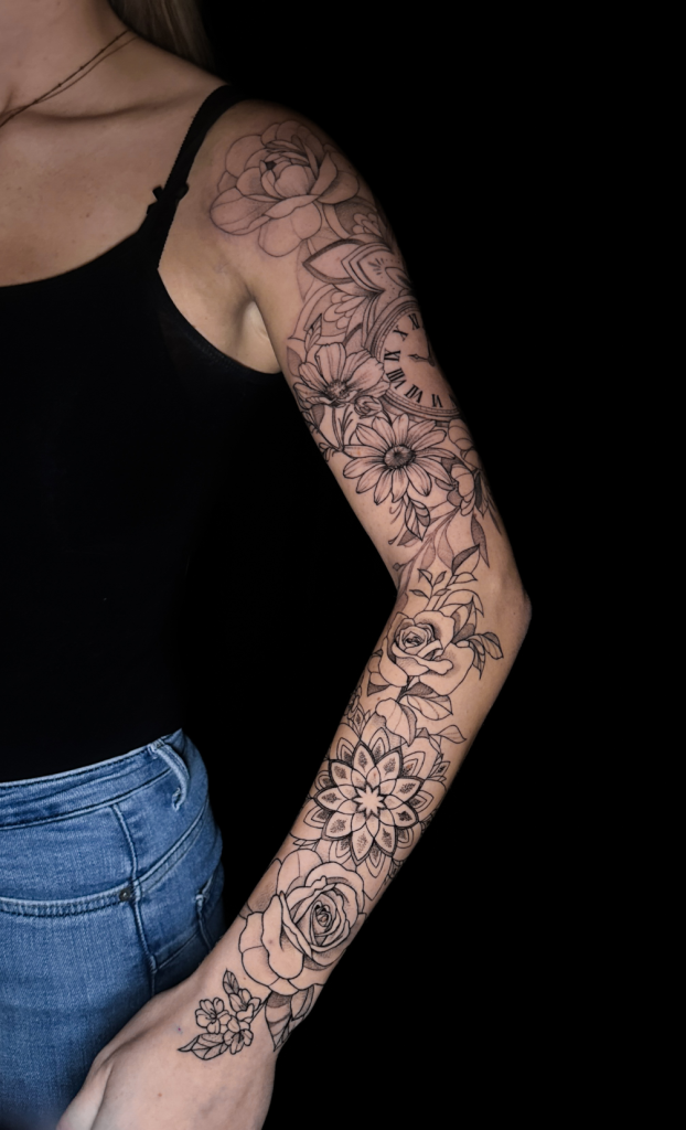 Manga floral completa tatuada en el brazo, del hombro a la muñeca
